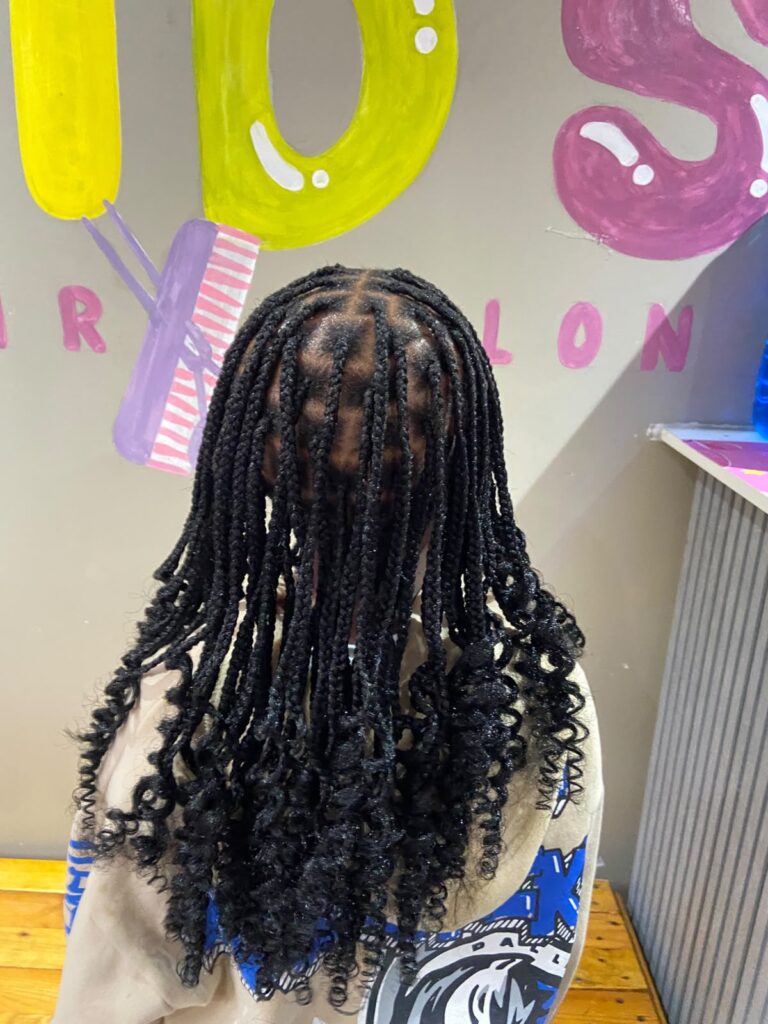 Colourful festive kids hairstyle at Melza Kids Hair Salon