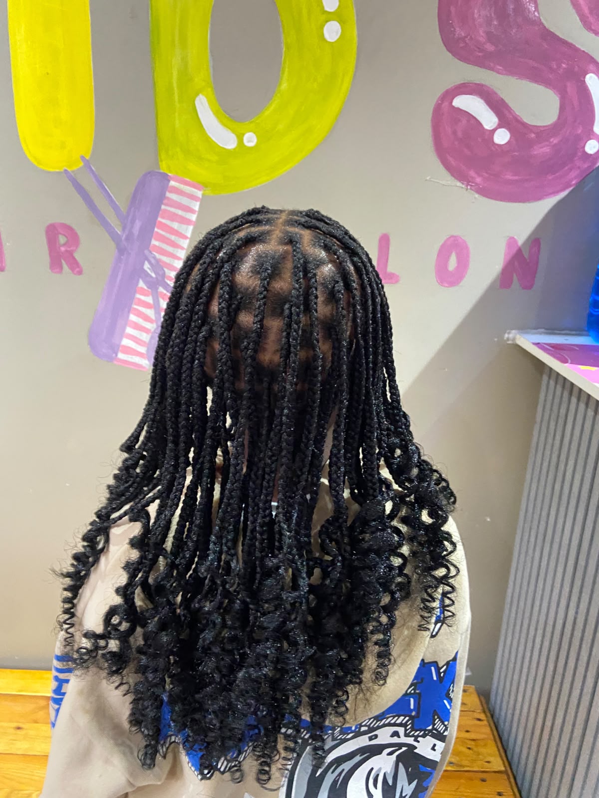 Colourful festive kids hairstyle at Melza Kids Hair Salon